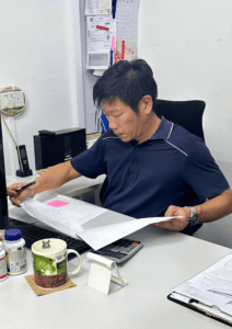 Roger from rodex movers working at an office desk